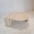 Very elegant Italian coffee table handcrafted out of travertine, 1980s. The beautiful teardrop shaped top is rounded on...