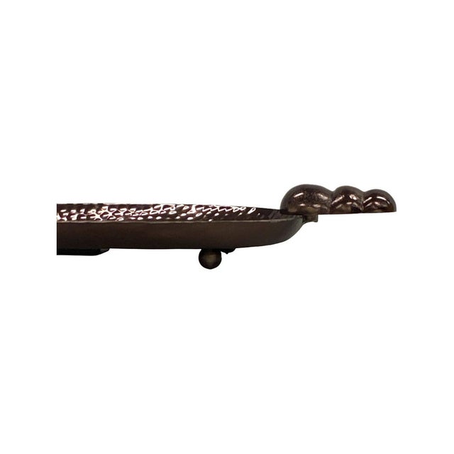 Featuring a oval hammered metal surface and distinctive stepped bubble handles, this tray brings texture, shine, and...