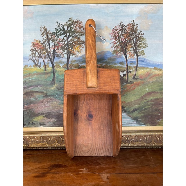 This vintage grain scoop is a finely hand-carved utility piece crafted from solid hardwood, showcasing the natural beauty...
