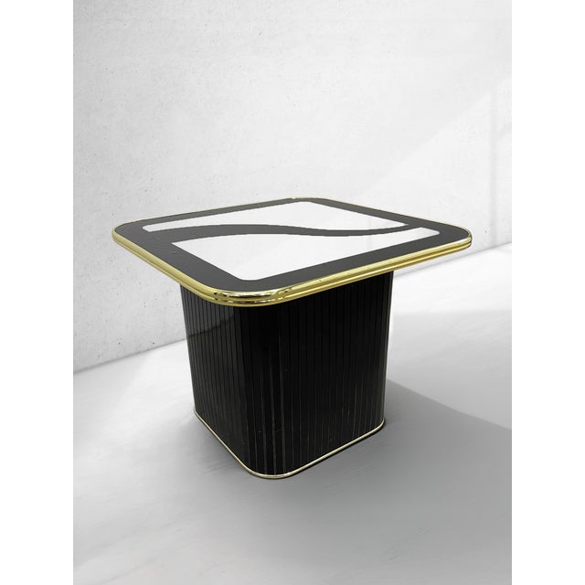 Striking vintage postmodern side table dating to 1994, featuring a square smoked glass top with a bold black graphic...