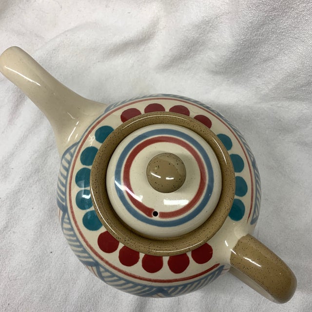 This is a vintage Franciscan Ventura Teapot featuring a speckled tan base and a colorful geometric tribal pattern with...