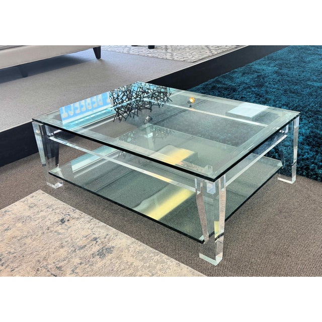 Two-Tier Lucite and Glass Coffee Table. Featuring 3/4" thick glass and thick lucite legs. Excellent pre-owned condition...