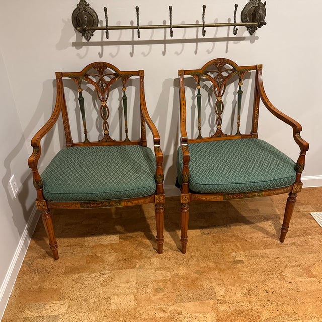 A wonderful pair of high quality British bench made armchairs in the Adams taste with painted neoclassical accents. Caned...