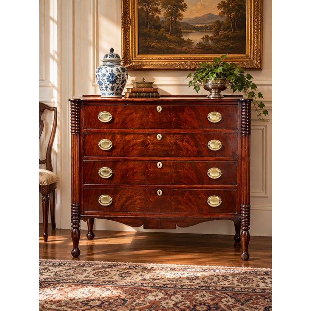 A handsome mid-19th century Sheraton cookie-corner four drawer chest in mahogany, showing the lingering classical...