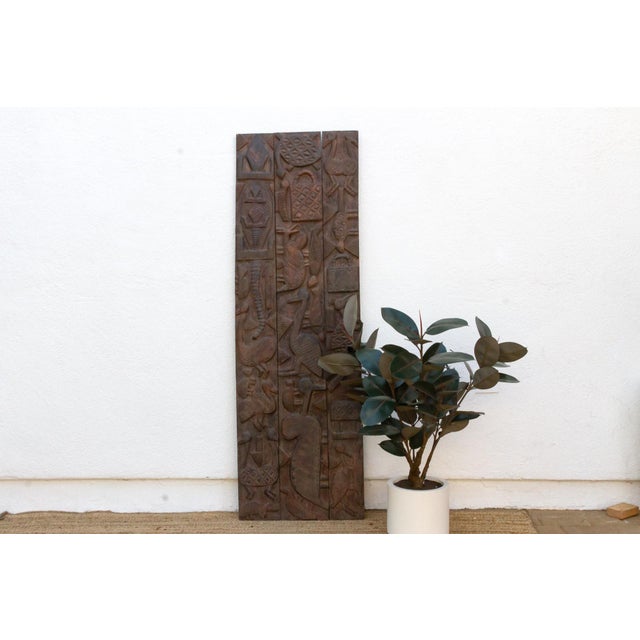 This 71-inch door is a Nupe piece from Nigeria's Niger River basin, carved across joined vertical planks and braced on the...