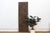 This 71-inch door is a Nupe piece from Nigeria's Niger River basin, carved across joined vertical planks and braced on the...