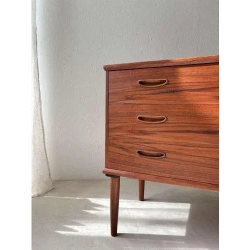Beautiful Danish design chest of drawers from the 1960s, crafted from high-quality teak veneer and featuring subtle...