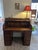 An impressive director’s desk with a roll-top shutter, filled with clever compartments and drawers for ideas, letters, and...