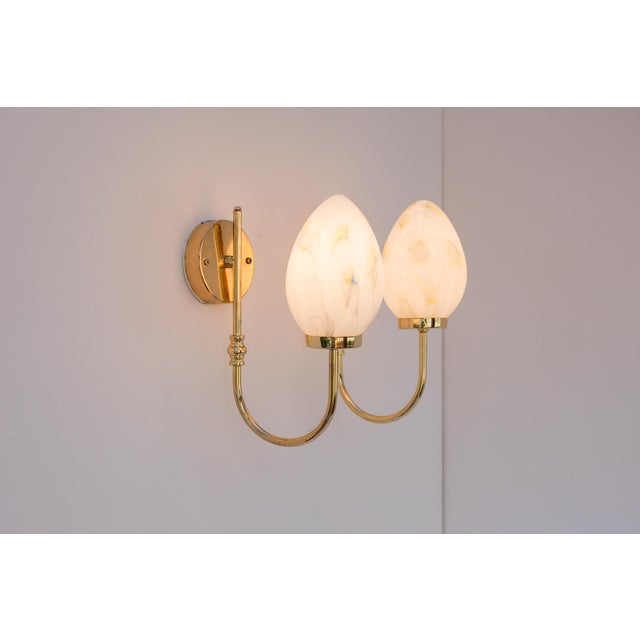 A pair of elegant wall lamps produced by Markslöjd, Sweden, circa 1980s. The lamps feature a refined and timeless design,...