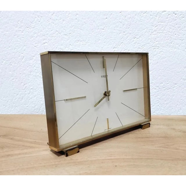 In this listing you will find an elegant Hollywood Regency Table Clock by Kienzle. It is made in solid brass, with the...