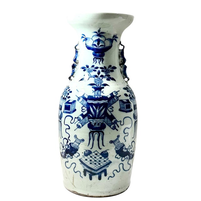 A graceful 19th century Chinese blue and white porcelain vase with a subtle celadon cast to the glaze, adding depth and...