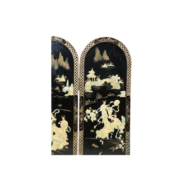 This vintage Chinese four-panel room screen is constructed from lacquered wood. It features black lacquer embellished with...