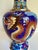 Here is a stunning, mid-20th-century Chinese cloisonné vase featuring a fantastic dragon and phoenix rendered in richly...