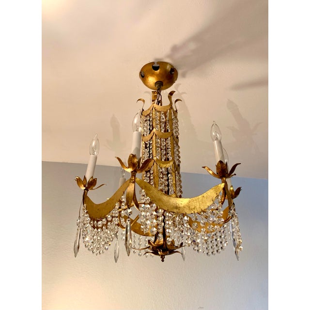This stunning vintage crystal chandelier dates from the middle of the twentieth century and would properly be called 1940s...