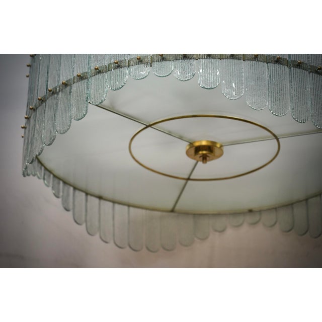Stunning chandelier/ceiling light in a striking transparent ice color; a perfect round with ice-colored glass plates. Its...