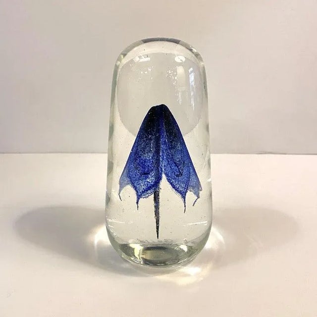 Artisan-made, hand-blown, art glass paperweight by Rochester Folk Art Guild features a graceful, cobalt blue form...
