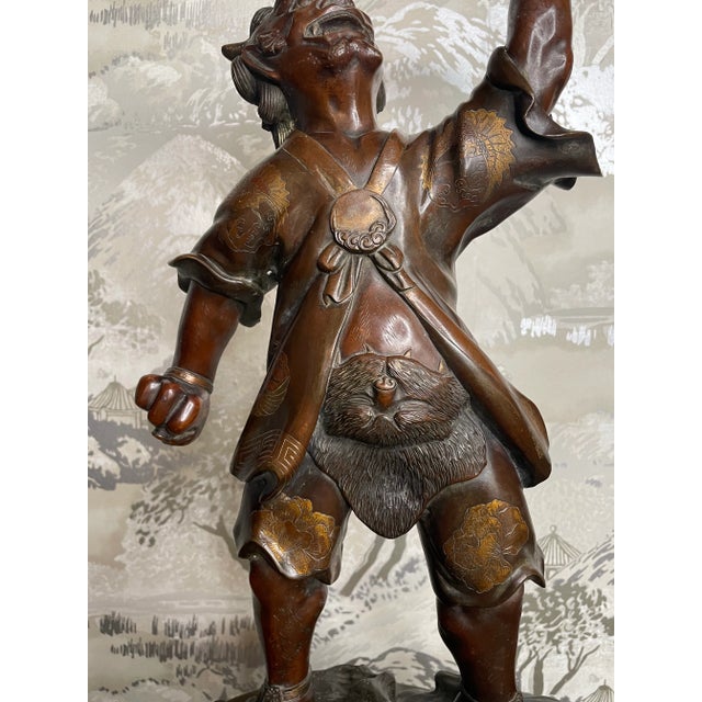 A magnificent Japanese bronze and parcel gilt Oni from the Meiji period. Cast in the style of Miyao Eisuke, standing with...