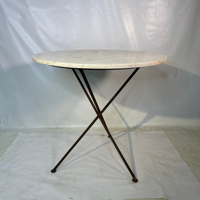 Great solid table dating to the 60s Quality made with beautiful round marble top and gray wrought iron base with a nice...