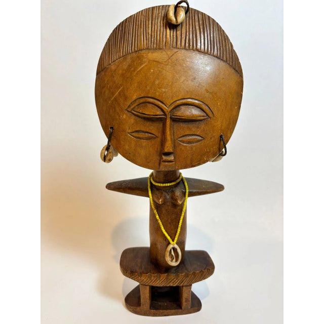 A highly expressive Ashanti (Asante) Akua’ba fertility figure from Ghana, dating to circa 1930–1940, hand-carved in wood...