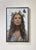 This artwork depicts a serene figure adorned with a crown of butterflies, creating a striking contrast against a soft,...