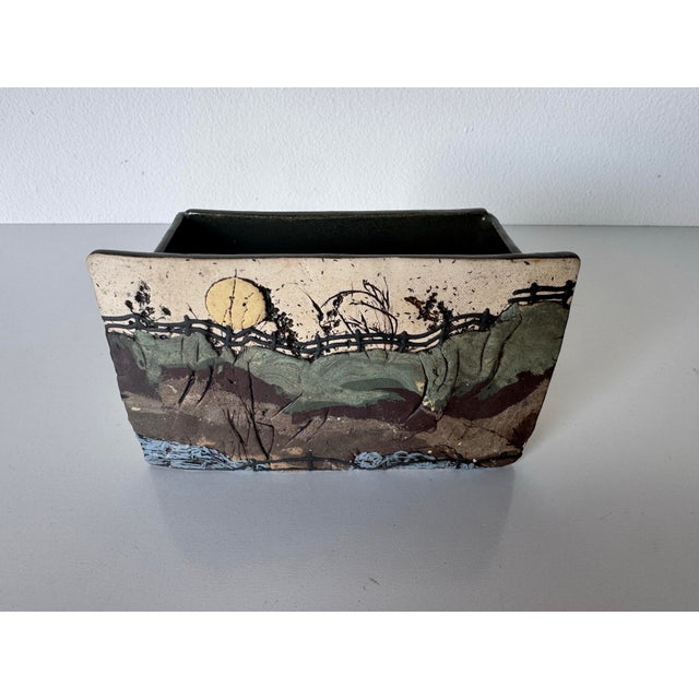 This striking vintage studio pottery vase dates to 1983 and features a beautifully executed landscape-inspired relief...