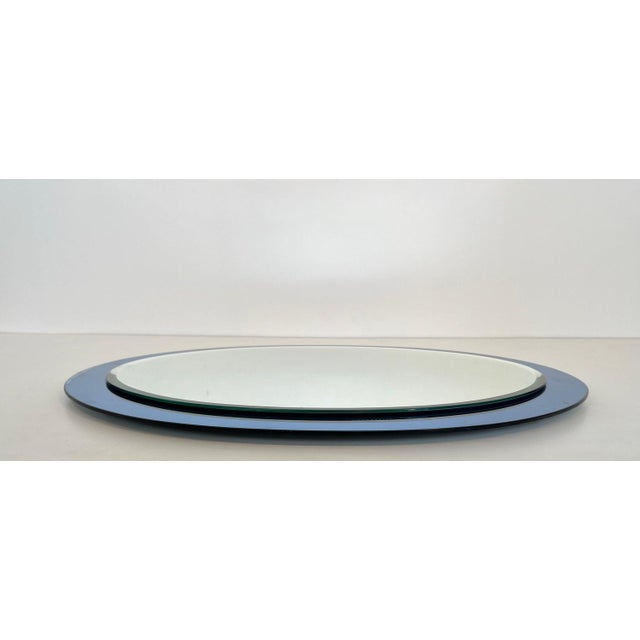 This beautiful oval shaped mirror is composed of an oval mirror with a blued surround (some wear on the edge of the...