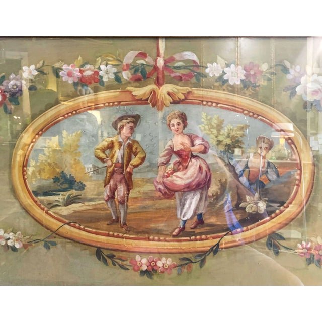 Delicately rendered in a soft Rococo palette, this antique Aubusson gouache presents a charming pastoral fête galante....