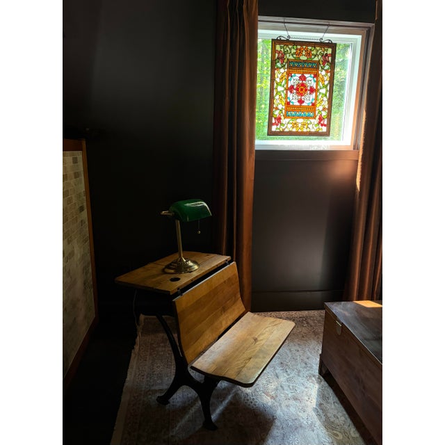 Early 20th-century school desk by A. Flanagan Co. of Chicago, featuring a cast iron base, hardwood construction,...