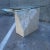 Large console sofa table with beveled octagonal glass top, brass x-support, atop smooth polished and rough cut tessellated...