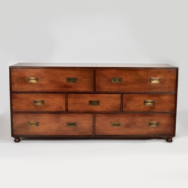 Handsome vintage British Colonial style chest crafted in walnut with seven drawers having brass campaign hardware and...