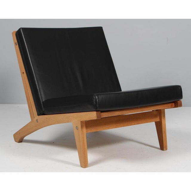 Hans j. Wegner lounge chair with loose cushions new upholstered with full grain aniline leather. Frame of solid soap...