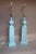 A striking pair of late 20th century neoclassical style table lamps featuring tall fluted obelisk forms in a soft matte...