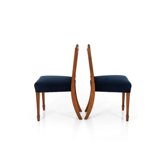 A wonderful pair of James Shoolbred occasional chairs in mahogany. The gothic style chairs have a square back with four...