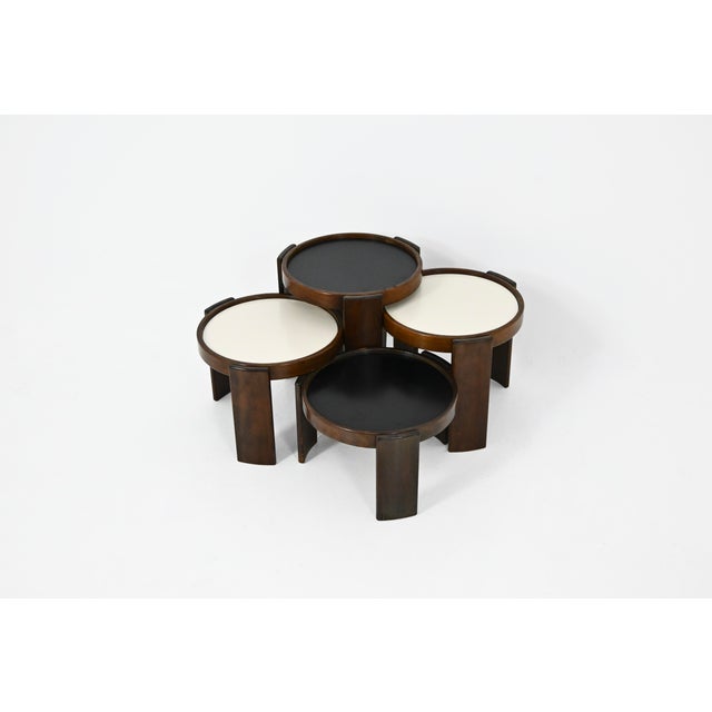 Wooden nesting table. Reversible black and white top. Stamped Cassina. Wear due to time and age of the table. Measures:...