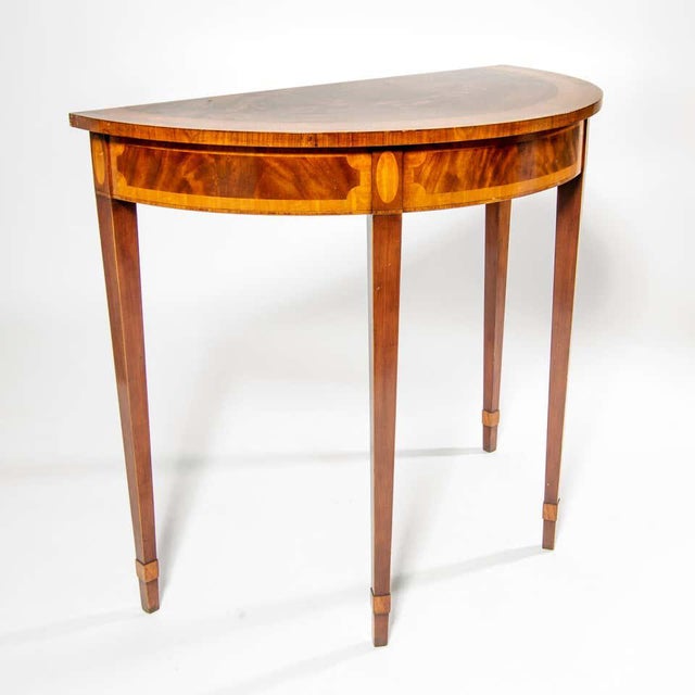Beautiful neoclassical directoire style demi lune console table rendered in mahogany with exquisite inlay marquetry of...