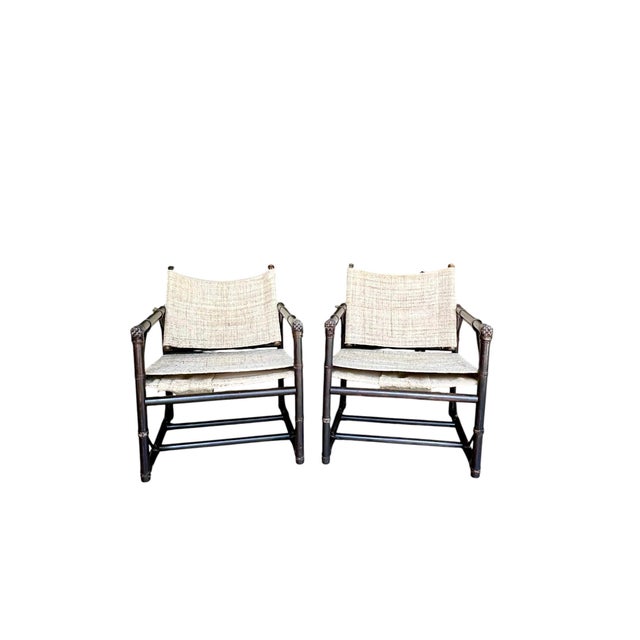 An exceptional pair of vintage campaign-style safari lounge chairs attributed to Forbes for McGuire, showcasing the...