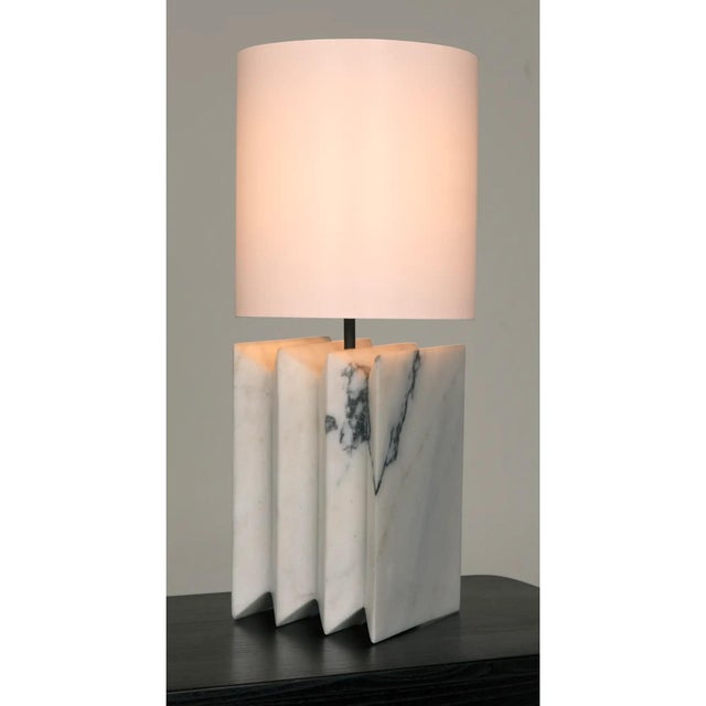 Beautifully hand crafted from white marble, the Jman table lamp can bring an elegant lighting experience to any room.