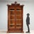 Late 19th-century walnut display cabinet from Italy, featuring an elegant structure with a pair of glass doors and a...