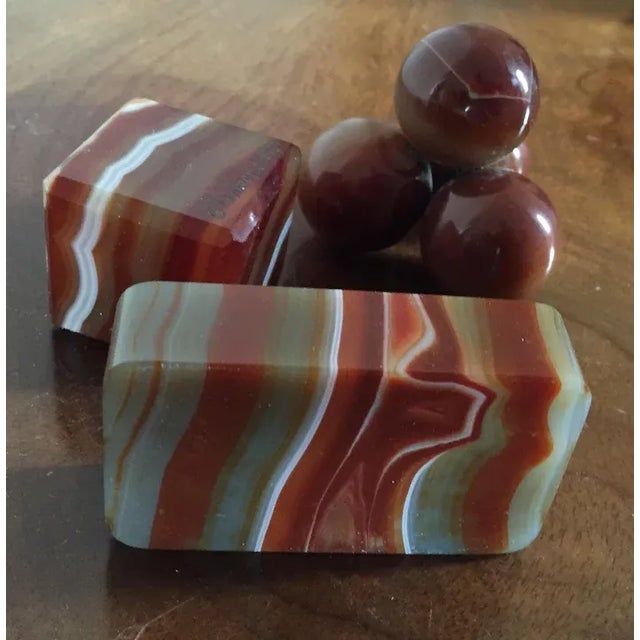 Collection of three antique 19th c. banded agate paperweights. The first in the form of cannon balls stacked into a...