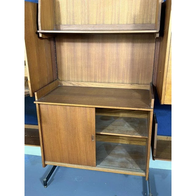 Good vintage condition with trace of age and use for this wall unit made from wood and metal with brass details. The blue...