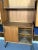 Good vintage condition with trace of age and use for this wall unit made from wood and metal with brass details. The blue...