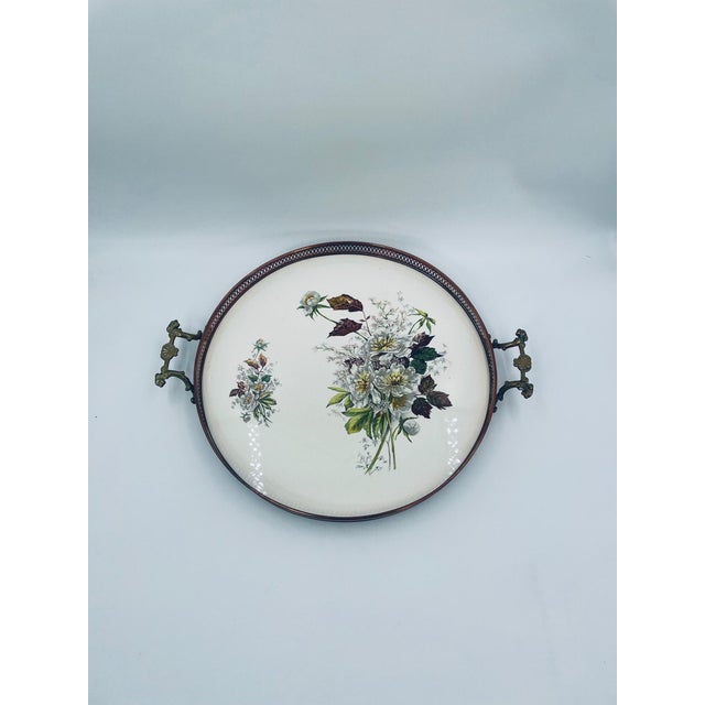 Antique Art Nouveau serving tray. Crafted from high-quality cream-colored ceramic, the tray features an openwork brass...