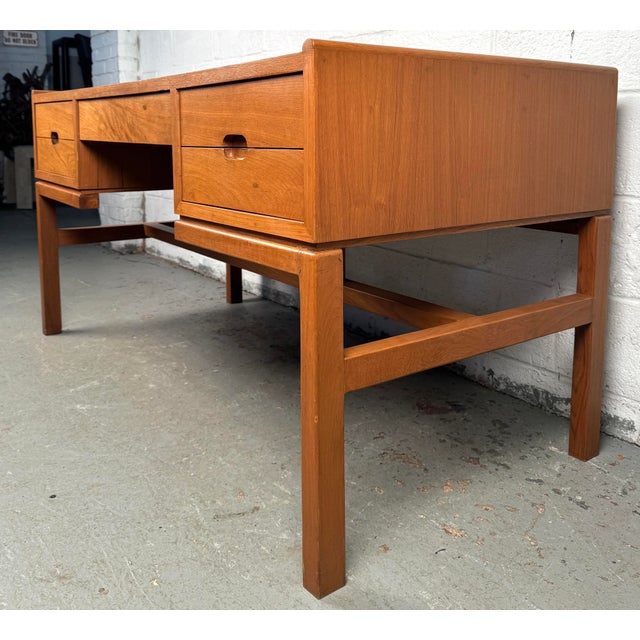 Elevate your workspace with this stunning mid-century teak desk designed by Arne Wahl Iversen, a masterful example of...