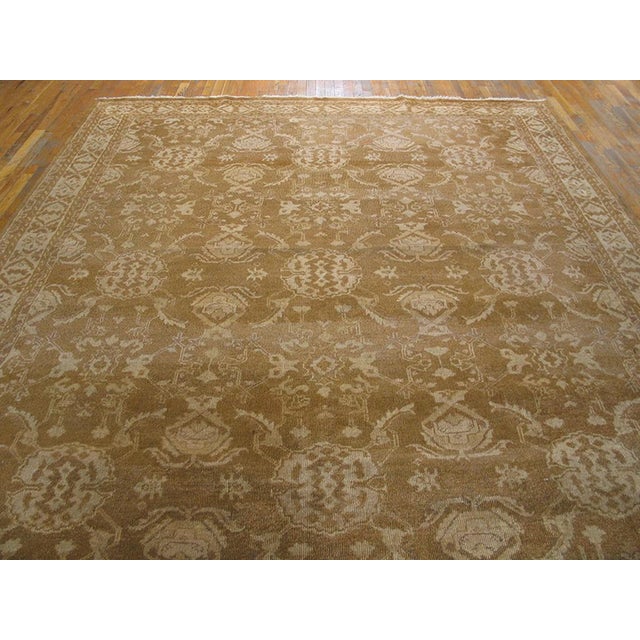 Although Turkish Oushak carpets are not often Agra inspirations, this rust-camel colored allover patterned piece comes...