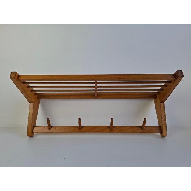 This Midcentury modern wall-mounted coat rack was produced in Czechoslovakia, Uluv-Krasna Jizba, during the 1970s. Made...