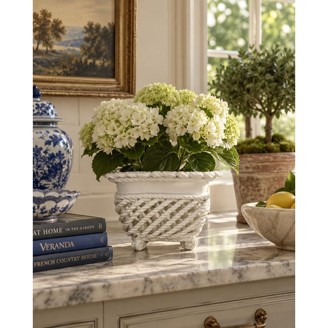 An elegant trompe l'oeil porcelain cachepot crafted in the form of a handwoven rope basket. Executed in glossy white...