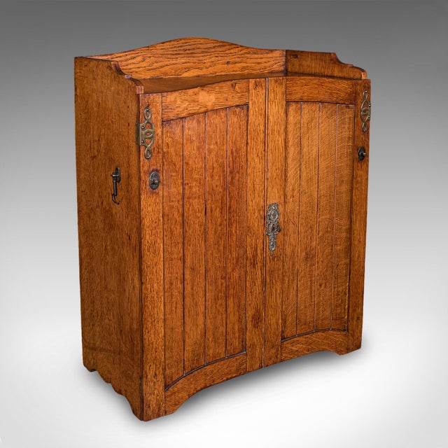 This is an antique estate gamekeeper's cabinet. A Scottish, oak table top or wall mounted clerk's cupboard in Arts &...