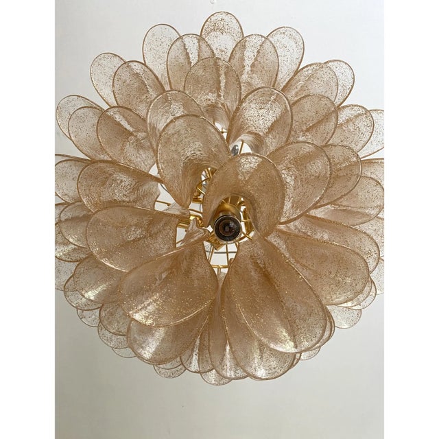Contemporary and LUXURY vintage Mazzega style chandelier. Clear and gold “Selle ” elements in Murano glass poured over a...
