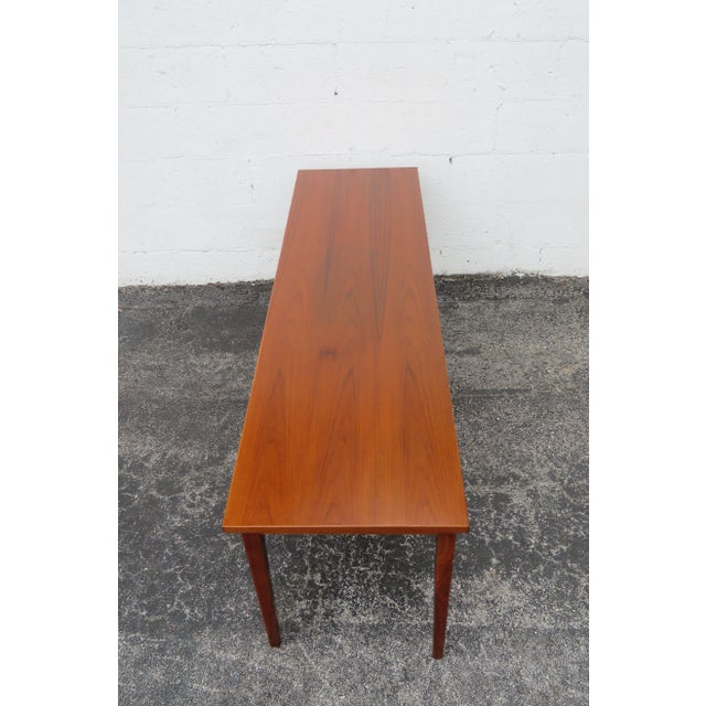 This gorgeous Coffee Table is made out of wood, walnut, and veneer. The Table stamped C F on the bottom. The Coffee Table...