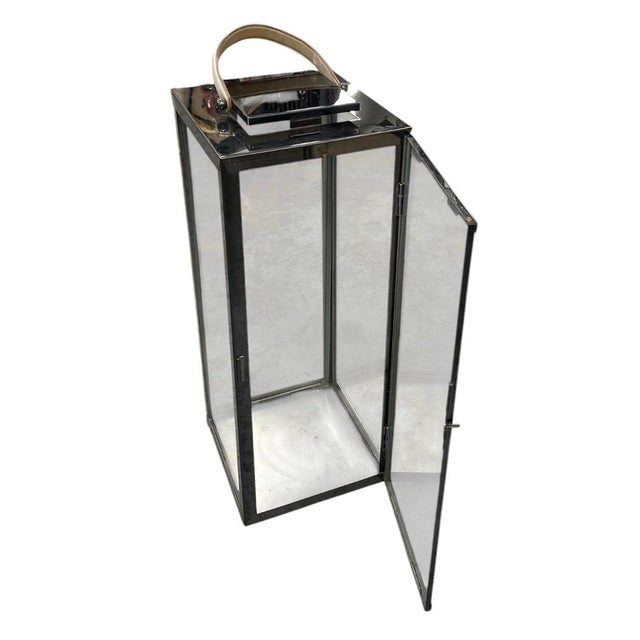 Elevate indoor or covered outdoor living spaces with this striking vintage-inspired floor lantern. Crafted with a sleek,...